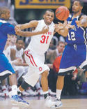 Daequan Cook goes for the ball against Memphis' Doneal Mack, left, and Antonio Anderson