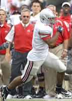 Knee surgery will sideline Brandon Saine, shown here making a play against the Washington Huskies as JT looks on.