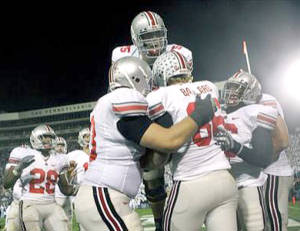 Ohio State's Jake Ballard (86), celebrates catching a third quarter touchdown with teammates during a college football game against Penn State in State College, Pa., Saturday, Oct. 27, 2007. Leaping high is Ohio State's Alex Boone (75).