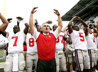 Ohio State coach Jim Tressel, center, begins to form an O as he sings with his players in front of fans after the team's 33-14 victory over Washington in a college football game Saturday, Sept. 15, 2007, in Seattle. (AP Photo/Elaine Thompson)