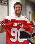 Scarlet Captain Alex Boone holds up the jersey of number one overall pick Thaddeus Gibson