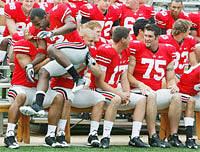 Malcolm Jenkins jumps on Marcus Freeman, left, and James Laurinaitis, right, as they prepare for the team picture at Ohio Stadium.