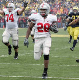 Ohio State tailback Chris Wells (28) runs for 62-yard touchdown as tackle Kirk Barton (74) begins to celebrate in the third quarter of a college football game against Michigan Saturday, Nov. 17, 2007 in Ann Arbor, Mich. (AP Photo (AP Photo/Duane Burleson)