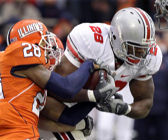 Ohio State's Chris Wells (28) runs through Illinois' Dere Hicks, left, during the first half of the OSU Illinois football game at the University of Illinois in Champaign, Ill., Saturday, Nov. 15, 2008. Ohio State defeated Illinois 30-20. (AP Photo/Seth Perlman)